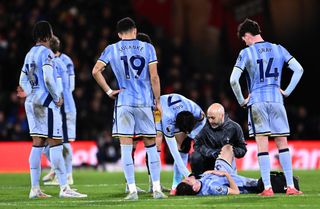 Ben Davies of Tottenham Hotspur requires medical attention after going down injured during the Premier League match between AFC Bournemouth and Tottenham Hotspur FC at Vitality Stadium on December 05, 2024 in Bournemouth, England.