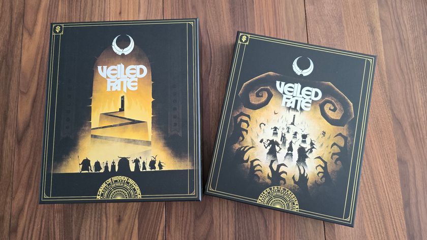 Veiled Fate box and expansion on a wooden table, seen from above