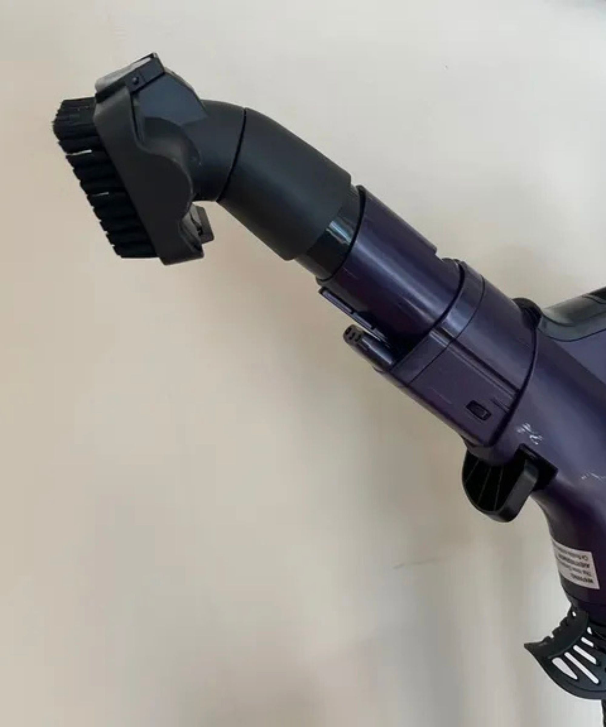 The Shark POWERDETECT Upright Vacuum multi-pet tool against a white wall in James Holland's home.