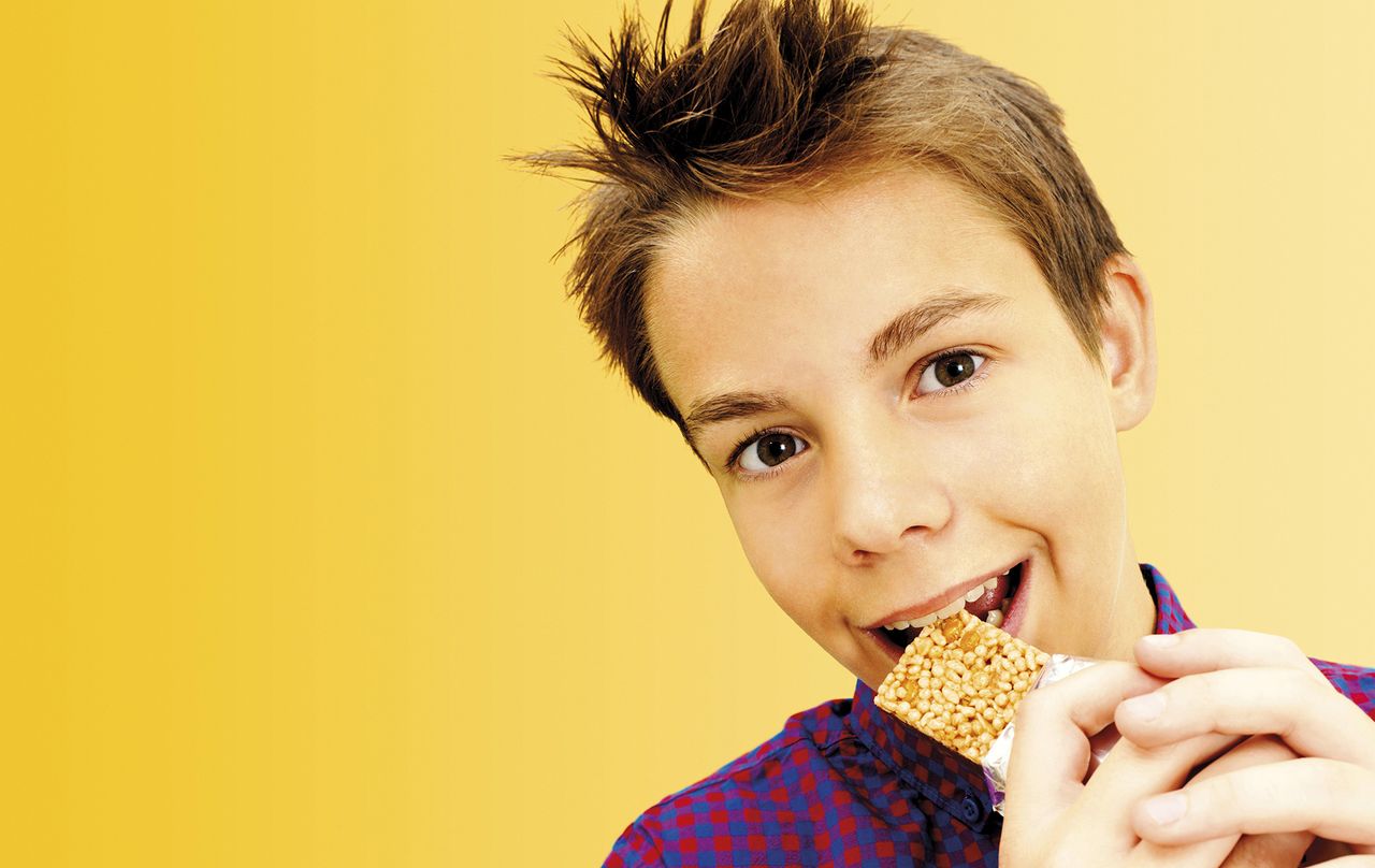 boy eating cereal bar