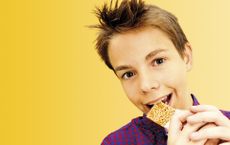 boy eating cereal bar