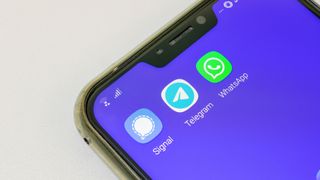 Smartphone displaying Signal, Telegram and WhatsApp applications