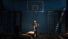 A Ukrainian police officer stands inside a school gymnasium in the village of Vilkhivka