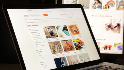 A digital tablet showing the Etsy marketplace homepage