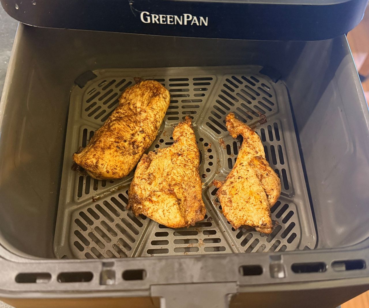 The GreenPan Bistro 360 Air Fryer open showing cooked chunks of chicken
