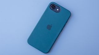 iPhone 16e in black on blue background