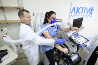 Memorial Sloan Kettering exercise physiologist Dan Townend conducts a cardiopulmonary exercise test to assess cardiorespiratory fitness on a patient.