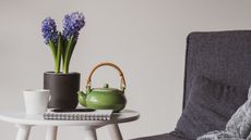 potted hyacinth on a table with a tea pot