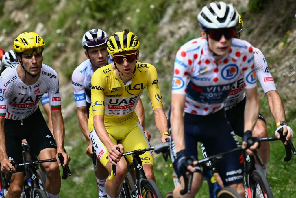 Soudal Quick-Step team's Belgian rider Remco Evenepoel wearing the best young rider's white jersey (2nd L) and UAE Team Emirates team's Slovenian rider Tadej Pogacar wearing the overall leader's yellow jersey (C) cycle behind Team Visma - Lease a Bike team's Danish rider Jonas Vingegaard wearing the climber's polka dot (dotted) jersey (second placed in the category) in the ascent of the Cime de la Bonette during the 19th stage of the 111th edition of the Tour de France cycling race, 144,6 km between Embrun and Isola 2000, in the French Alps, on July 19, 2024. (Photo by Marco BERTORELLO / AFP)