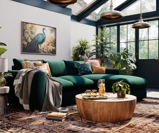 dark green sofa in conservatory with white walls and black roof and doors