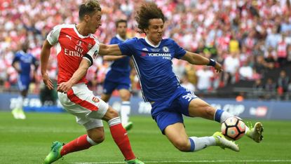 Mesut Ozil of Arsenal and David Luiz of Chelsea in action in the FA Cup final