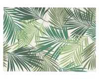 A tropical leaf print outdoor rug in shade of green