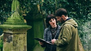 Robin and Pez talk in Highgate Cemetery in Strike: The Ink Black Heart