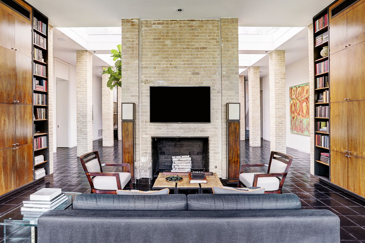 mid-century style living room with brick fireplace