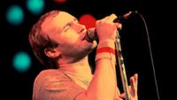 Phil Collins performing onstage in 1980