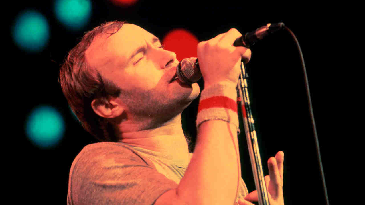 Phil Collins performing onstage in 1980