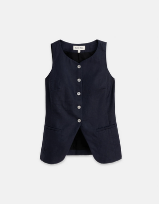 a navy sculpted alex mill vest in front of a plain backdrop