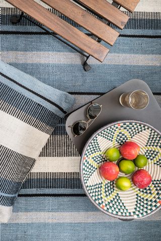 Blue and grey striped rug and matching cushion