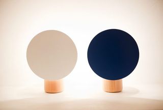 A pair of table lamps (white and blue) photographed against a white background