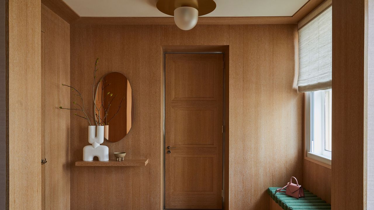 Modern wood paneled entryway with contemporary white vase and indoor tree by Paris Forino, Hudson Garruppo