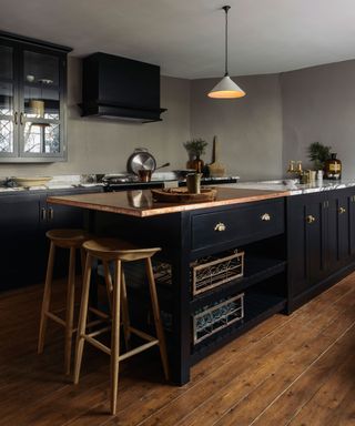 Farmhouse kitchen island in black with storage and stools