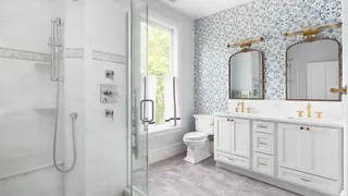 White bathroom with statement wallpaper