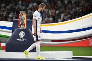 Harry Kane receives a silver medal and walks past the trophy at the end of the UEFA Euro 2024 final football match between Spain and England at the Olympiastadion in Berlin on July 14, 2024