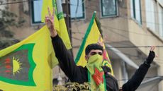 Syrian Kurds flash the V for victory sign as they celebrate the fall of capital Damascus to anti-government fighters, in the city of Qamishli on December 8, 2024. Islamist-led rebels declared that they have taken Damascus in a lightning offensive on December 8, sending President Bashar al-Assad fleeing and ending five decades of Baath rule in Syria. 