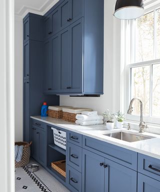 Laundry room with shaker cabinets painted dark blue