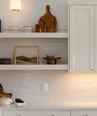 A white Shaker kitchen with open shelving finished with gallery rails