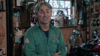 Mike Wolfe in a room full of signs and memorabilia on Season 25 of American Pickers.