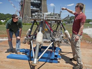 Marshall Center engineers Logan Kennedy, right, and Adam Lacock check out the lander prototype, dubbed the "Mighty Eagle." Since its last round of tests in 2011, the Mighty Eagle team has made significant updates to the guidance controls on the lander's camera, furthering its autonomous capabilities. Testing will continue through the month of August.
