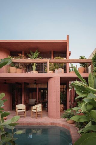 casa roja, a red house by angel garcia in mexico with indoor outdoor areas and terraces anda brutalist exposed concrete in red tone