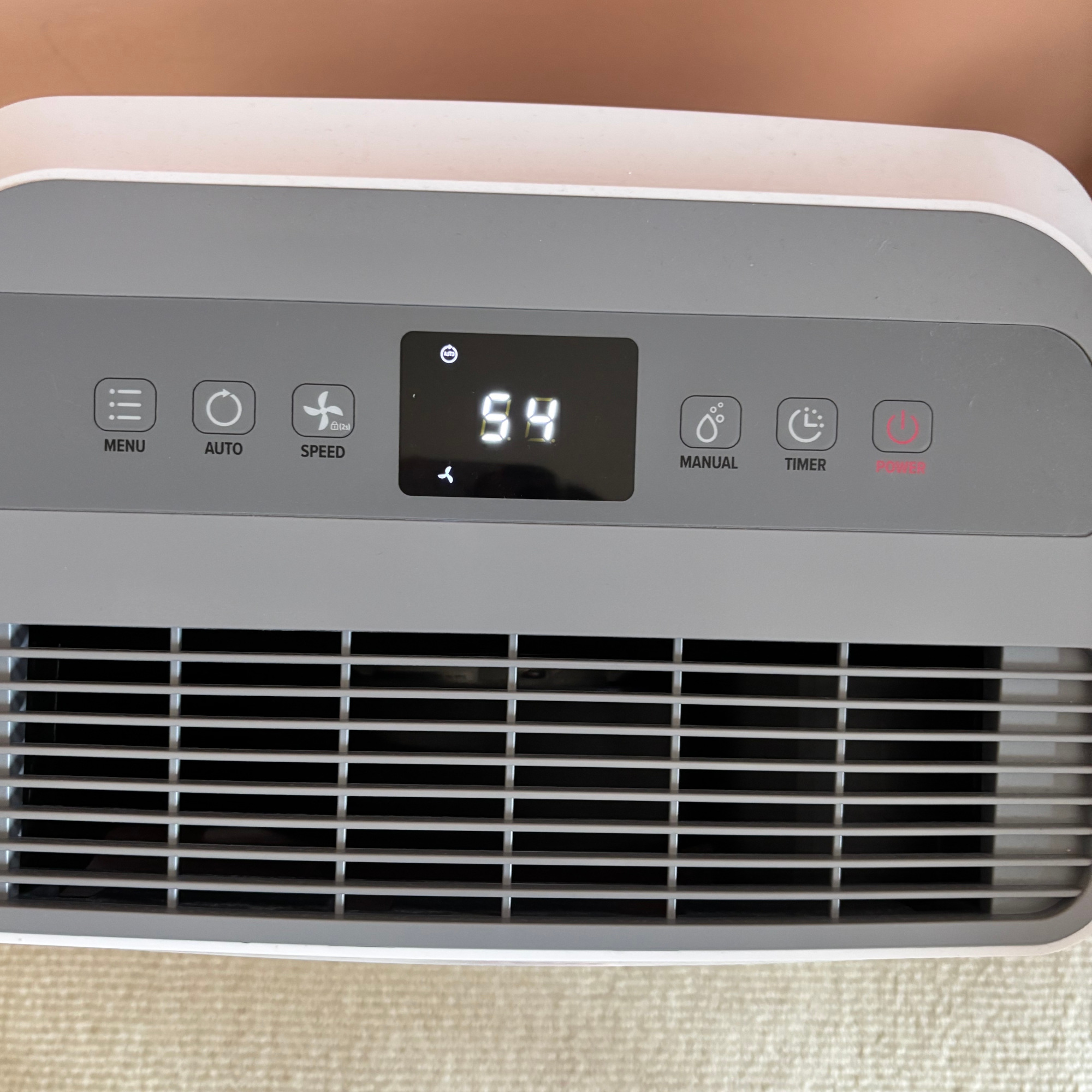 dryzone dehumidifier and air purifier display panel with lower humidity level in a bedroom