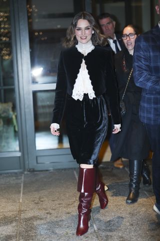 A photo of Keira Knightley matching her velvet Bermuda shorts to a black scalloped jacket in a head-to-toe Chloé look.