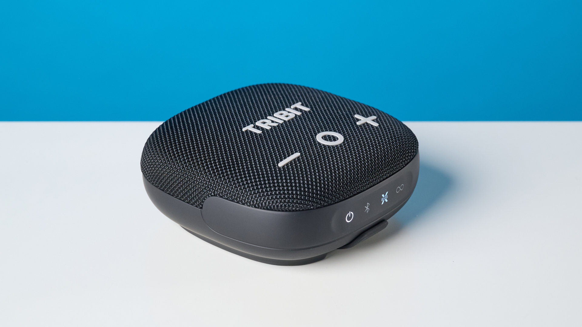Tribit StormBox Micro 3 in black photographed in front of a blue background