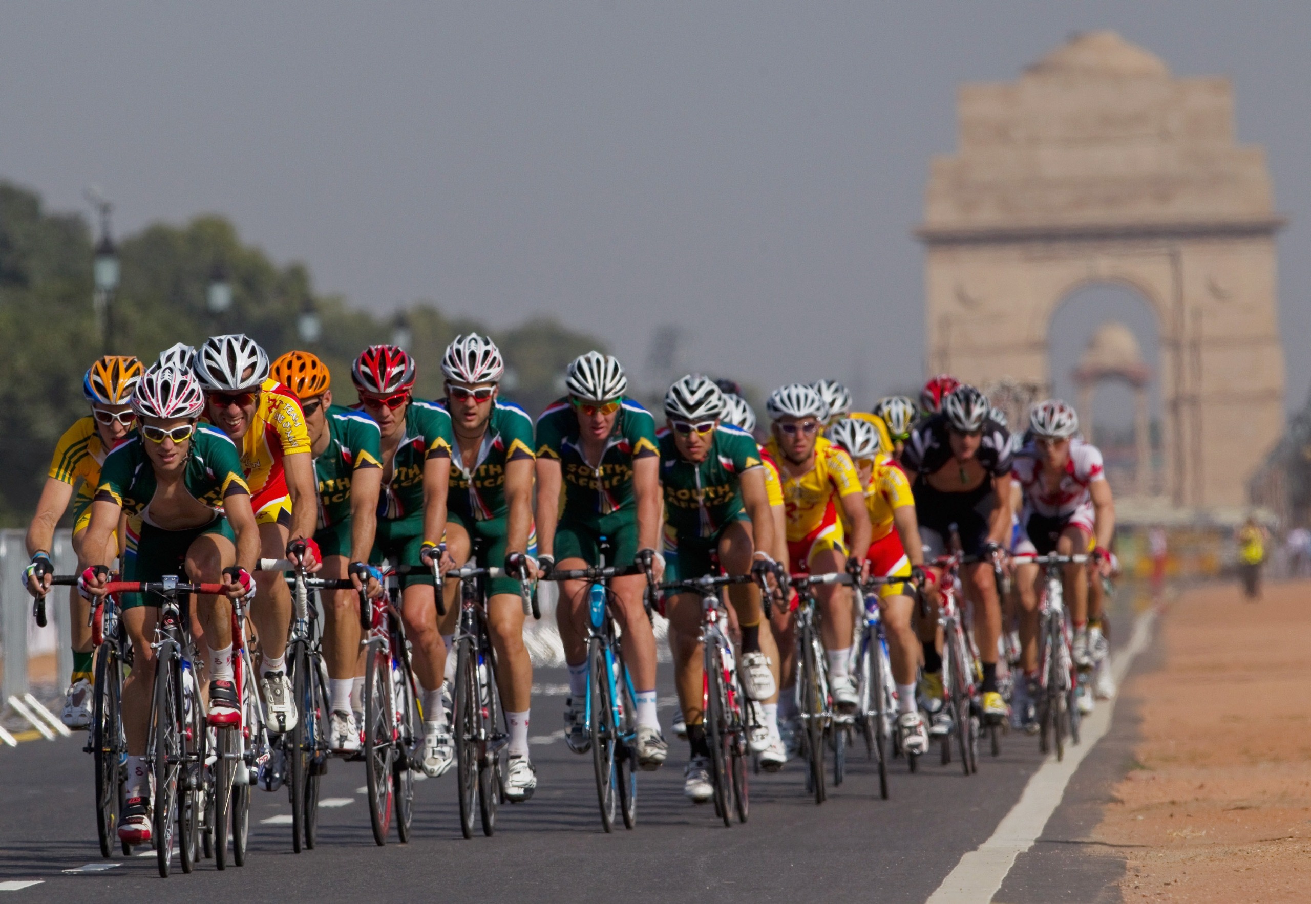 The peloton travels up Rajpath as they compete in the men's road race at India Gate during day seven of the Delhi 2010 Commonwealth Games on October 10, 2010