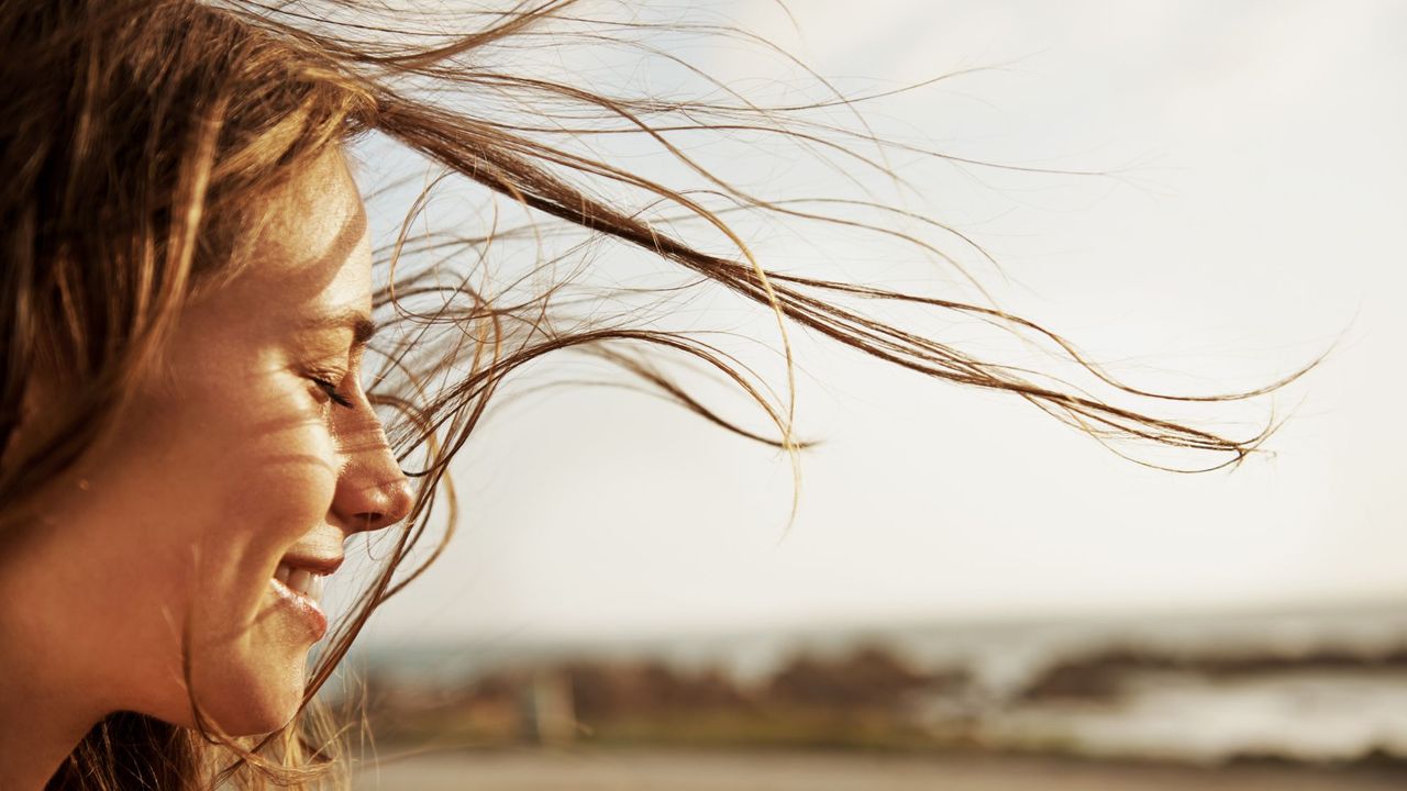 Cropped view of a young woman with the wind in her hair