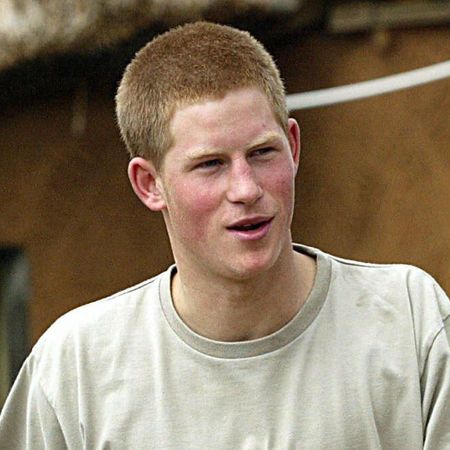 Prince Harry has very short red hair and is wearing an ecru T-shirt during his gap year in 2004 in Mohale's Hoek in Lesotho