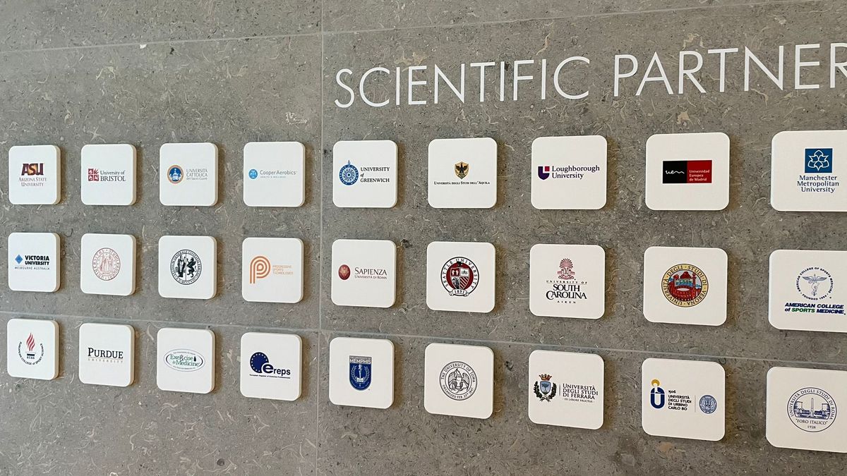 Plaques showing scientific partners at the Technogym village