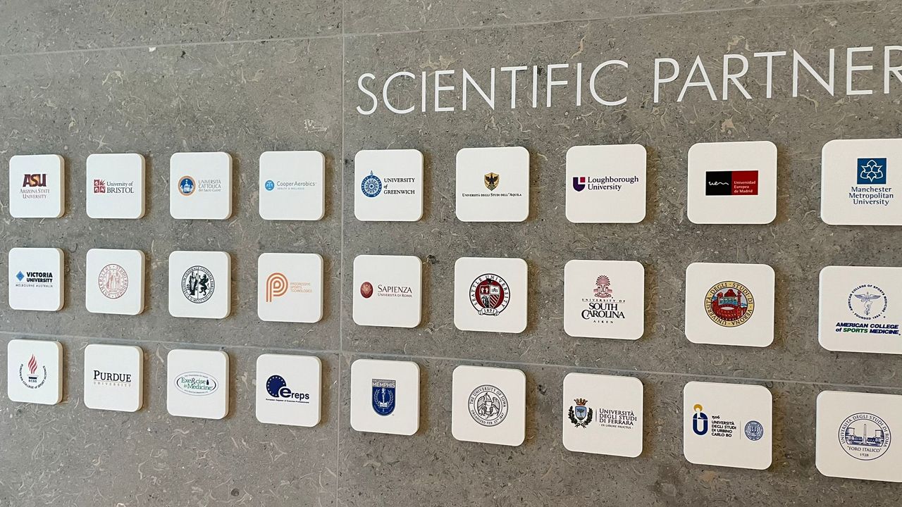 Plaques showing scientific partners at the Technogym village