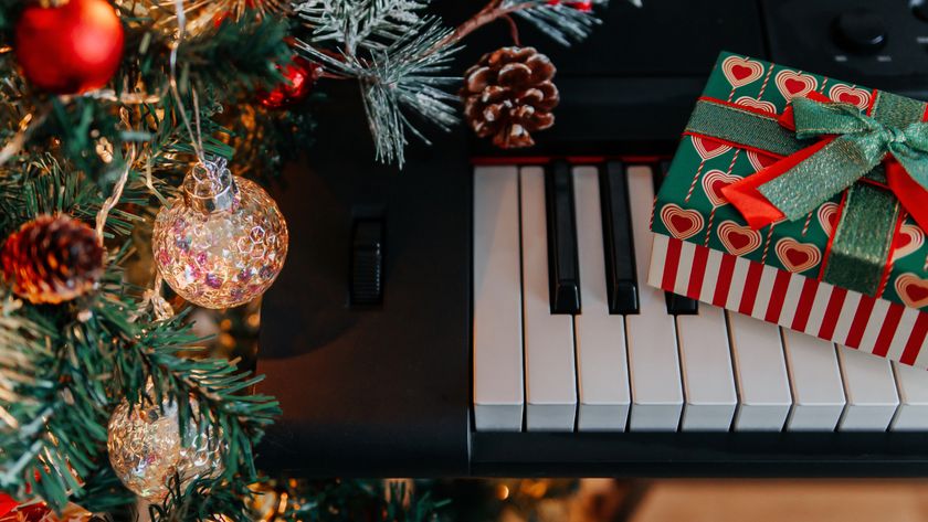 Piano under a Christmas tree with gifts