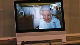 Queen Elizabeth II appears on a screen by videolink from Windsor Castle, where she is in residence, during a virtual audience to receive Her Excellency Sophie Katsarava, the Ambassador of Georgia, who was at London's Buckingham Palace.