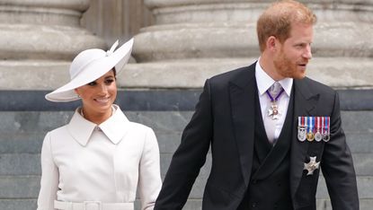 Prince Harry and Meghan Markle's Daughter Lilibet's first birthday portrait sitting in grass smiling in blue dress