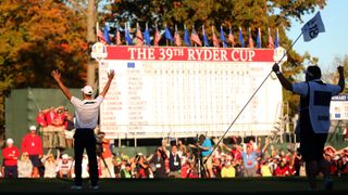 Martin Kaymer of Europe celebrates after making the winning putt as his caddie Craig Connelly watches on the 18th green to win The 39th Ryder Cup at Medinah