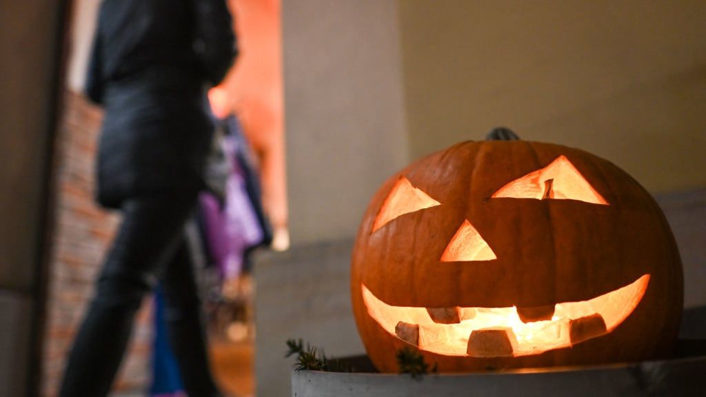 A jack-o&amp;#039;-lantern lit up at night.