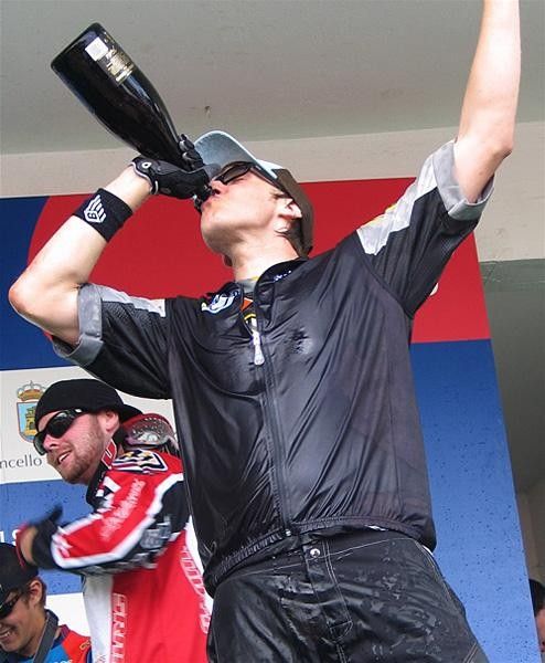 Steve Peat tucks into the champers in yet another podium appearance.