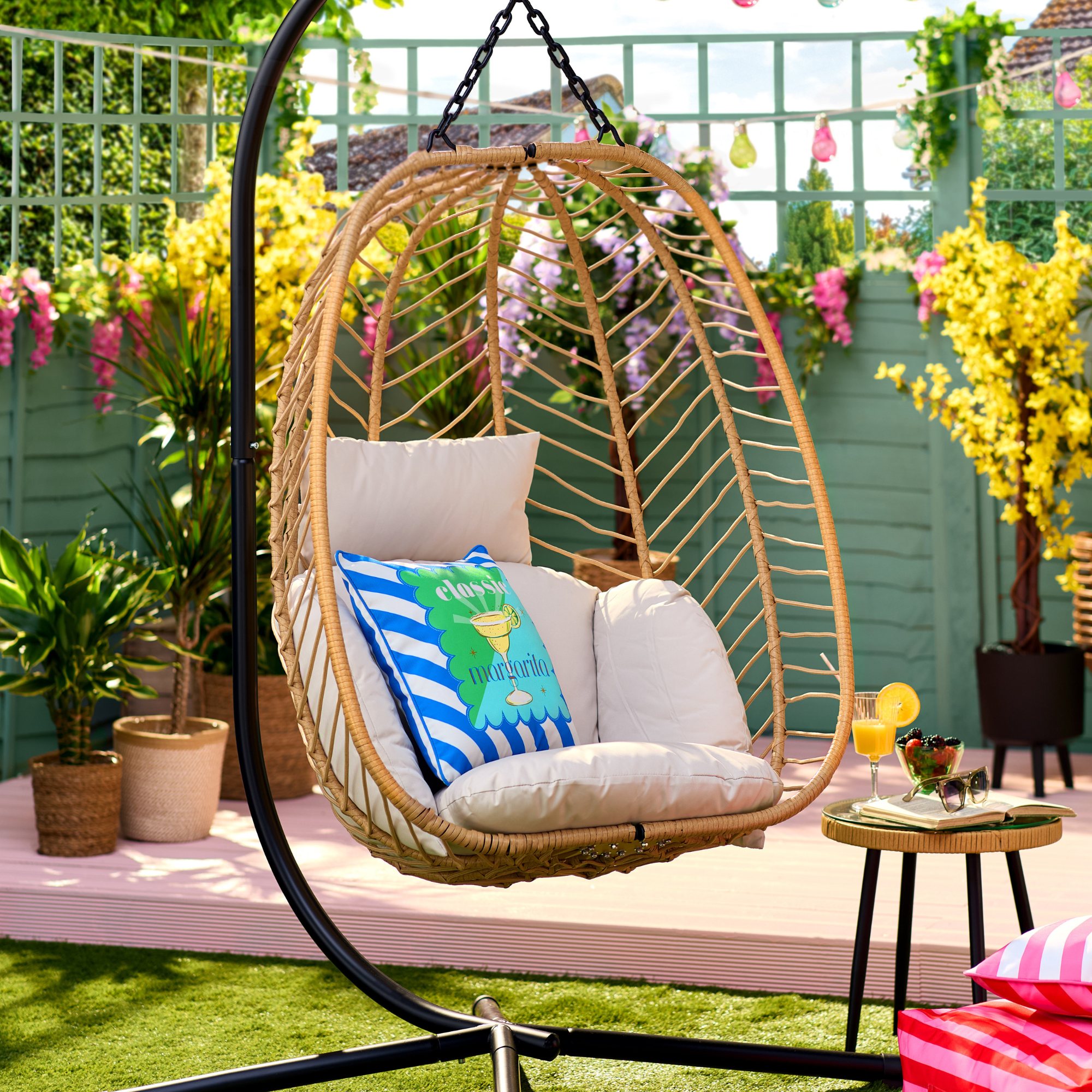 B&amp;amp;M Hampshire egg chair in a small garden. It has a margarita pillow to decorate.