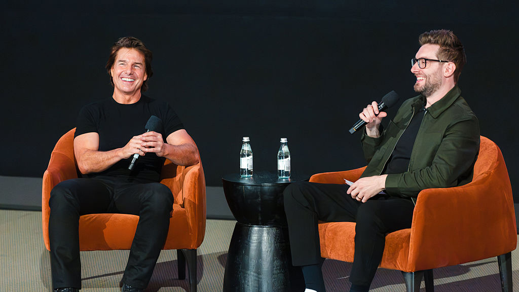 Tom Cruise and moderator Kevin McCarthy speak onstage at the trailer launch event for "Digger" at Warner Bros. Studios on July 09, 2026 in Burbank, California.