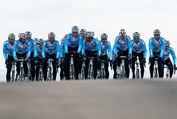 Team Milram crests a hill.